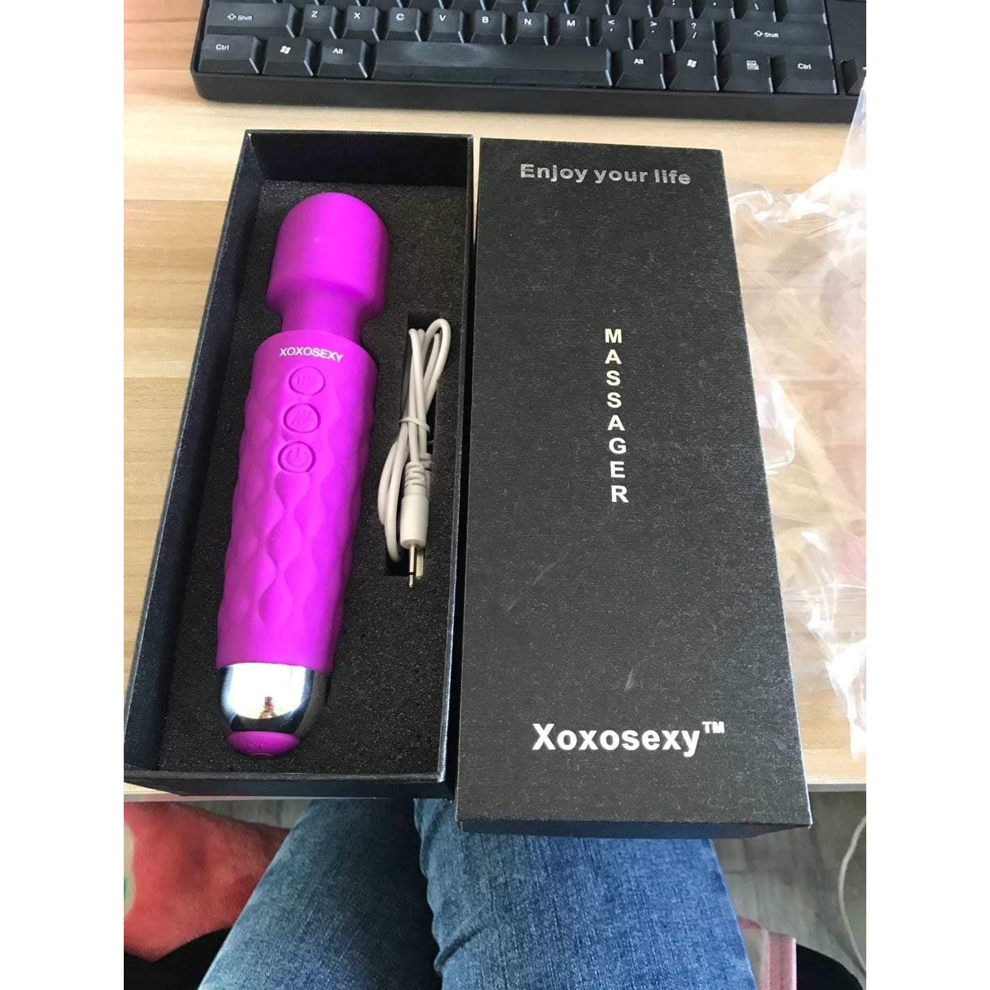 Someone holding the Pink/Purple Wand Massager with cover off